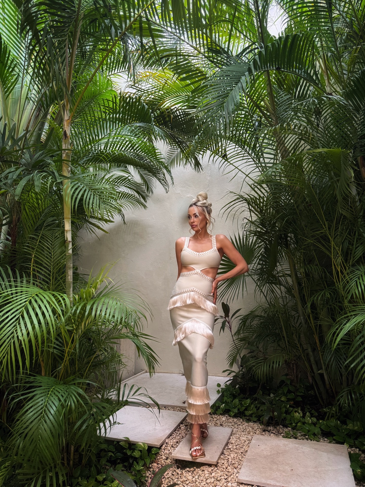 photograph of a women standing in a beautiful gown under tropical trees in Mexico Teresa